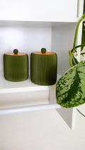 Ribbed green storage containers with terracotta lids 3D printed product